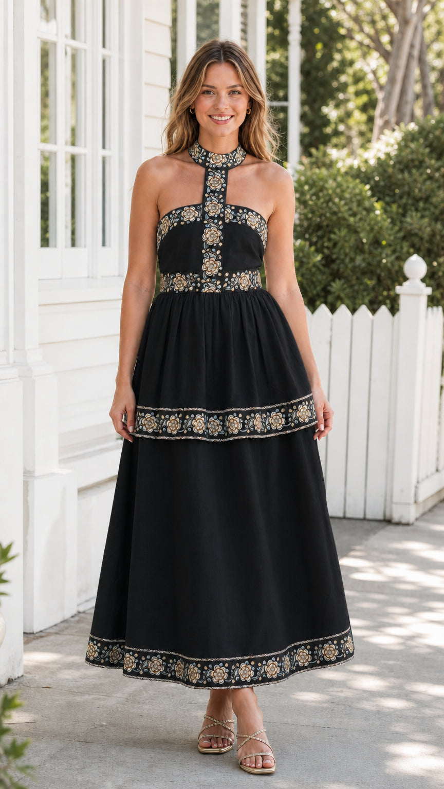 Model wearing black embroidered halter midi dress