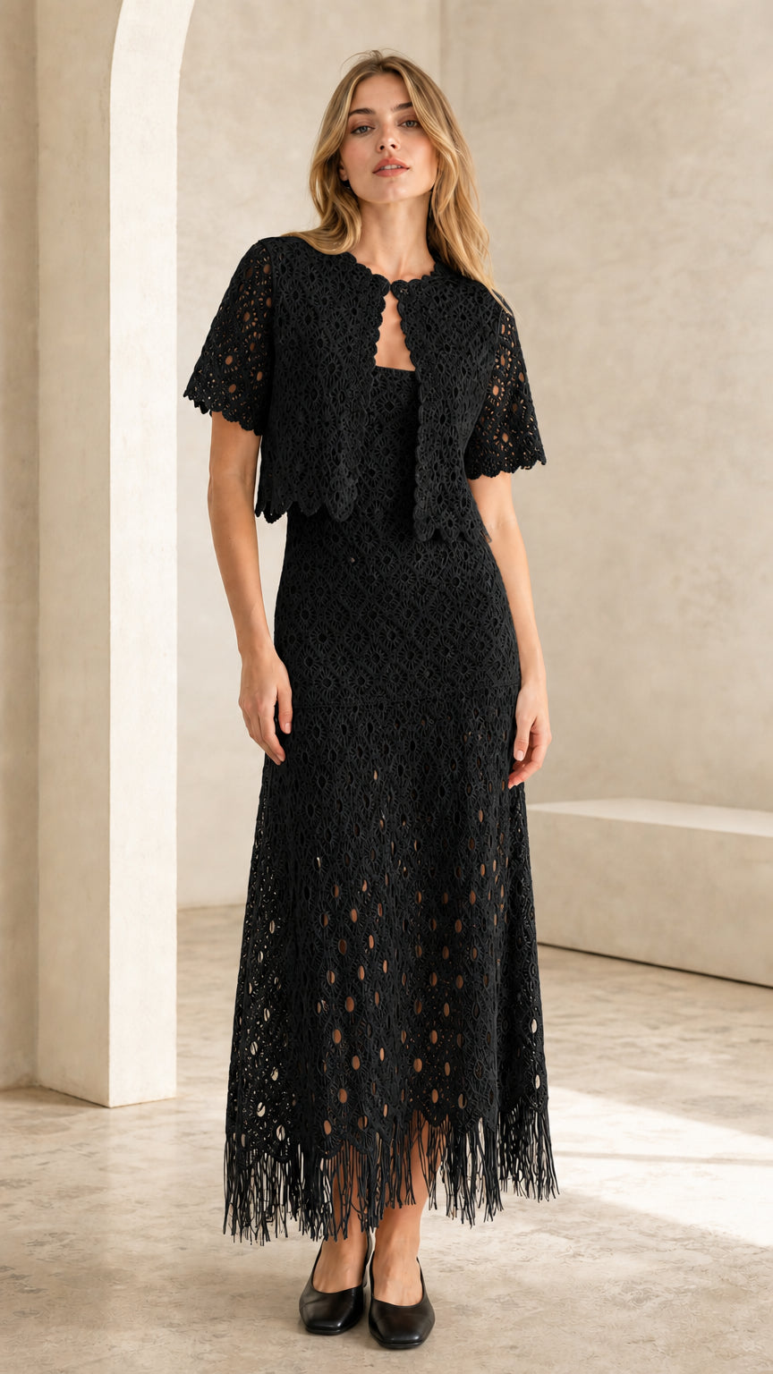 Front view of black crochet lace two-piece set on model