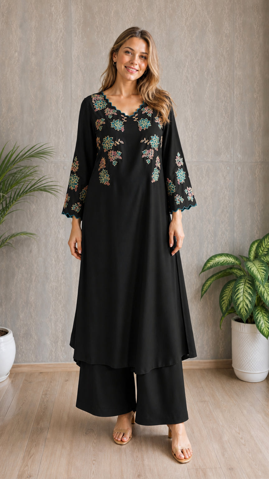 Model wearing black embroidered tunic and wide-leg pants set