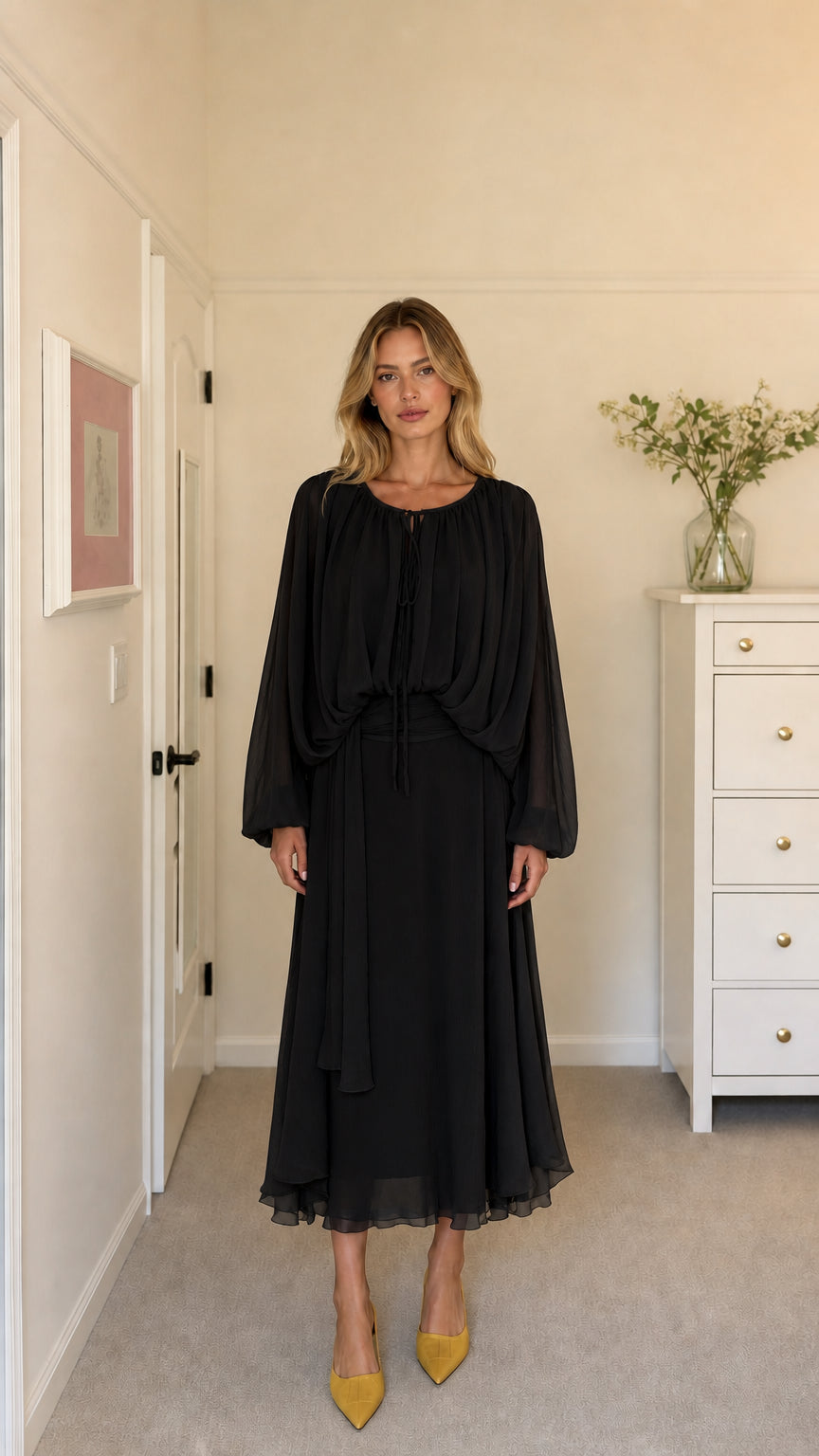 Model wearing black long-sleeve pleated midi dress