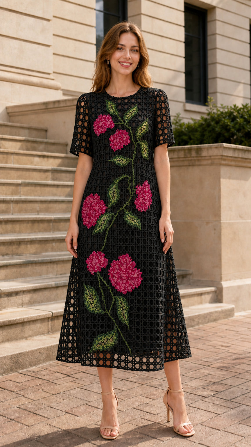 Front view of woman wearing black floral embroidered midi dress