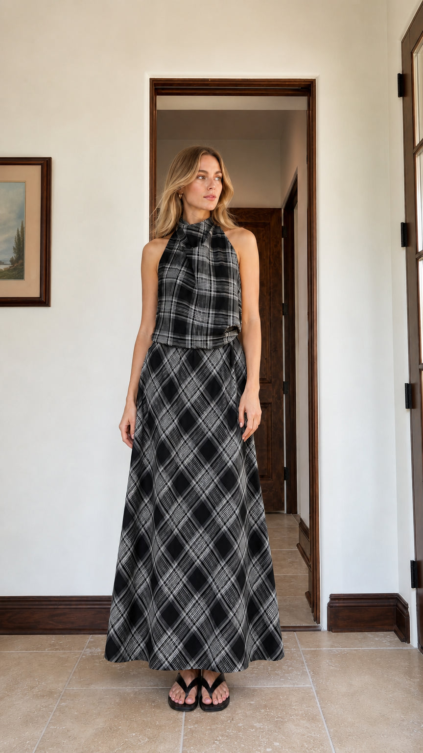 Woman wearing black plaid halter top and matching maxi skirt
