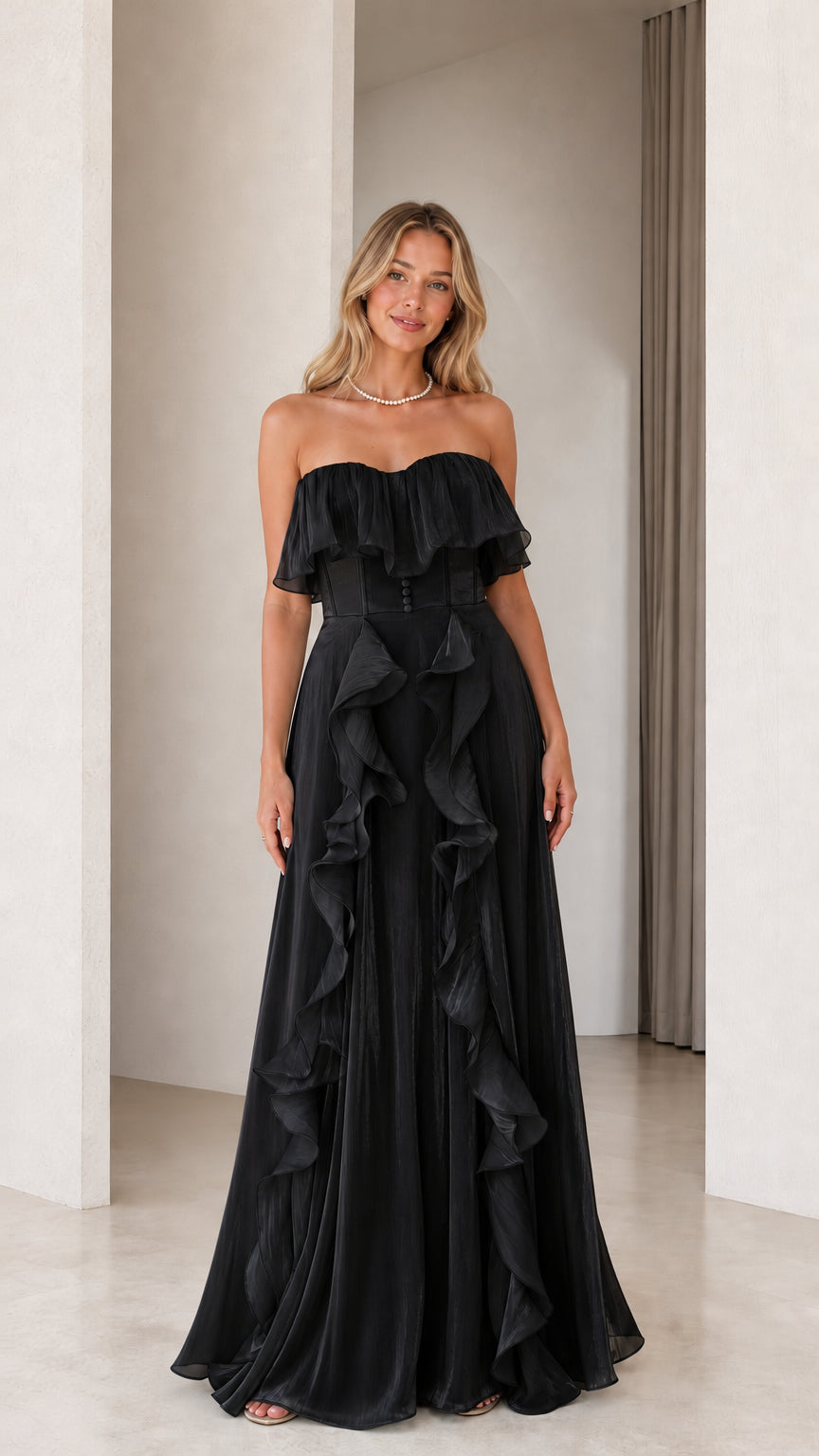 Front view of black strapless ruffled evening dress
