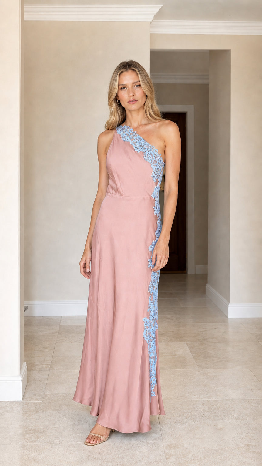 Front view of woman wearing pink one-shoulder satin maxi dress with blue lace applique