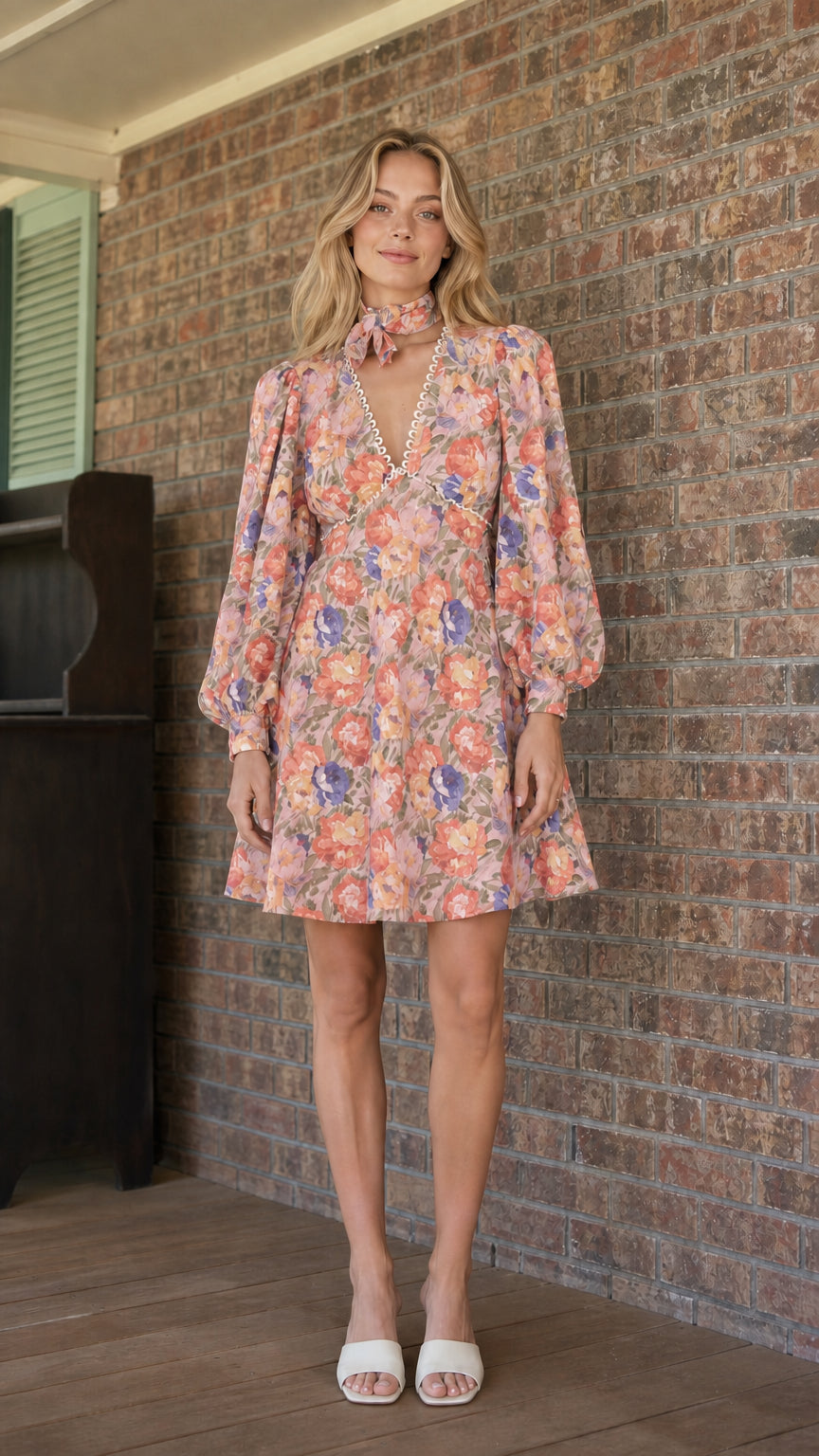 Model wearing pink floral print mini dress