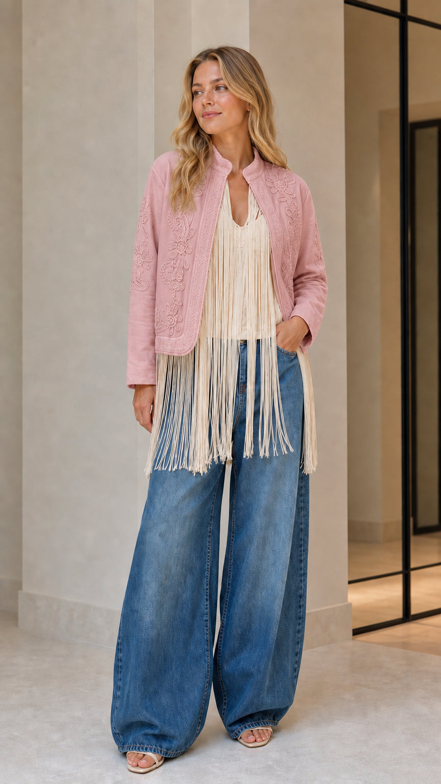 Model wearing pink embroidered fringe jacket
