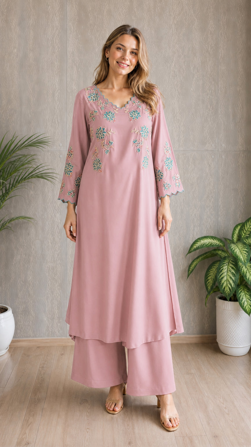 Model wearing dusty pink embroidered tunic and wide-leg pants set