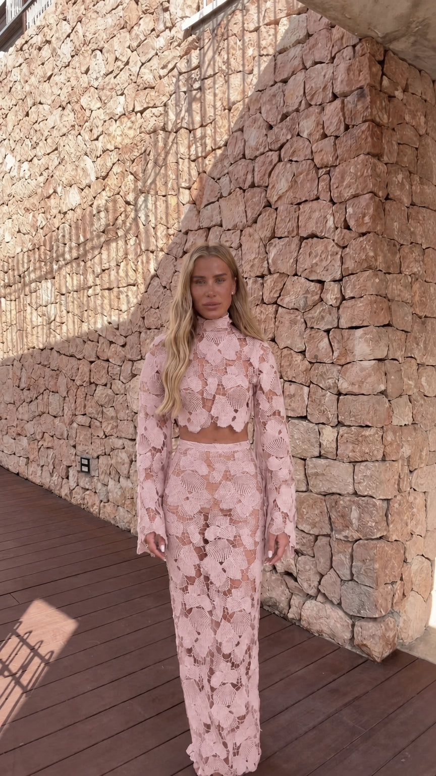 Model wearing light pink crochet lace two-piece set