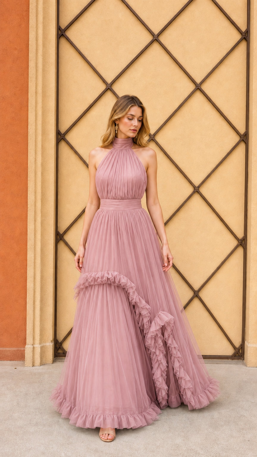 Model wearing dusty rose halter pleated tulle evening gown