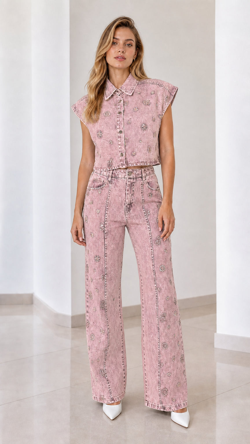 Front view of model wearing pink embellished denim vest and matching wide-leg pants