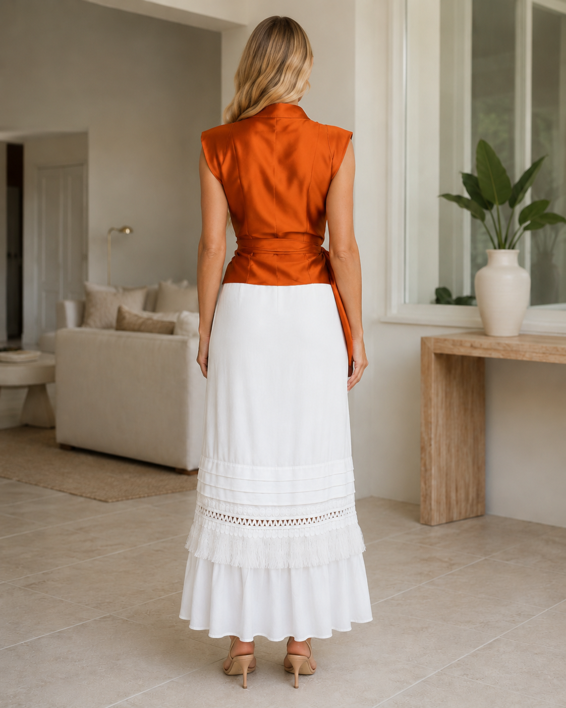 Back view of rust orange satin-look sleeveless blouse with smooth fitted waist