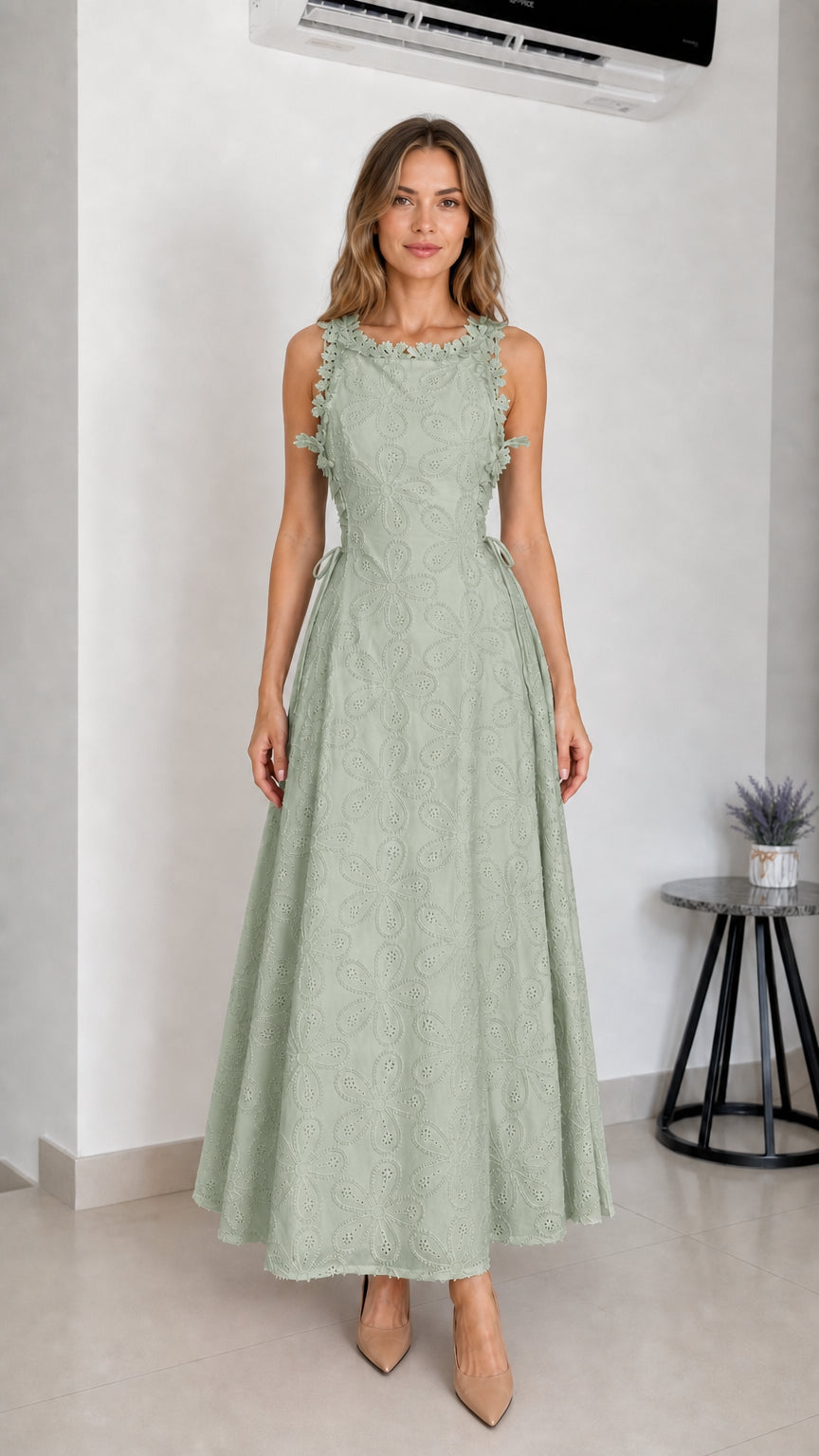 Model wearing sage green embroidered eyelet maxi dress