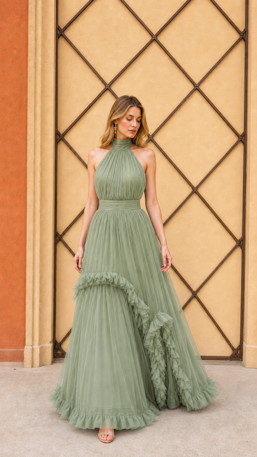 Model wearing sage green halter pleated tulle evening gown