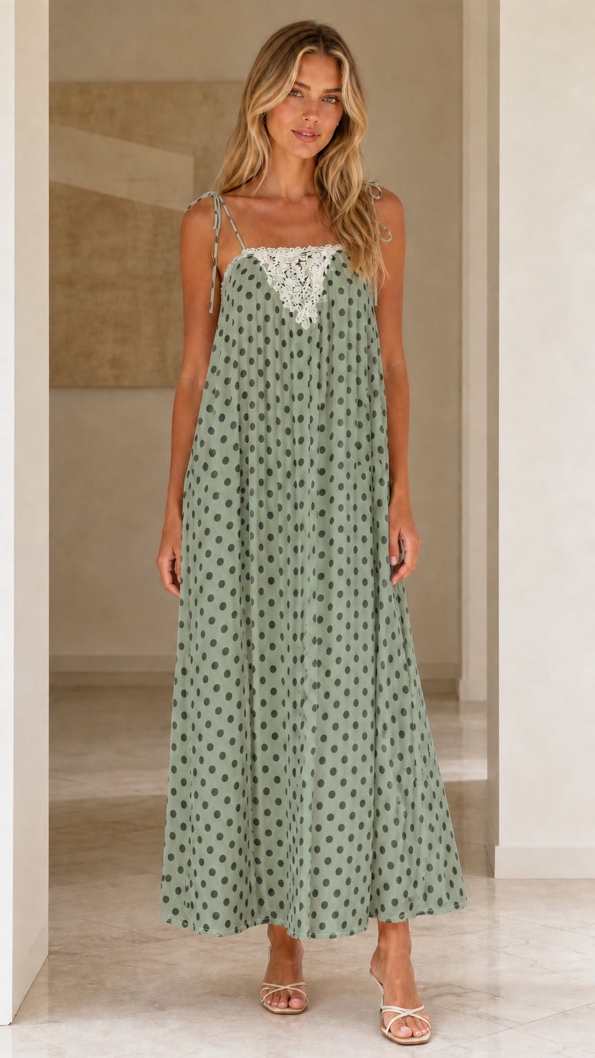 Front view of woman wearing sage green polka dot maxi dress