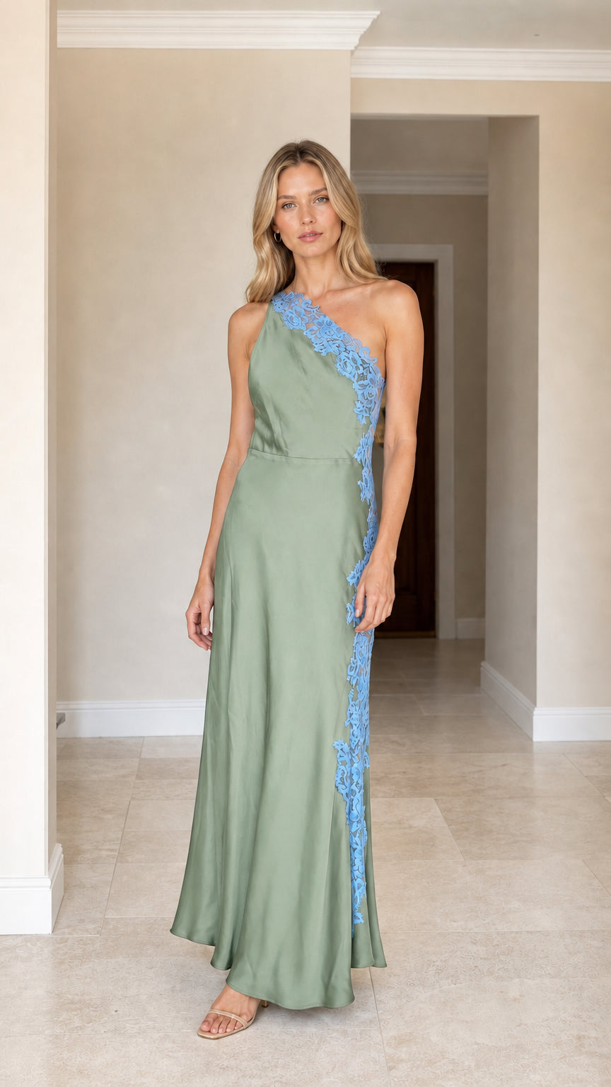 Front view of woman wearing sage green one-shoulder satin maxi dress with blue lace applique