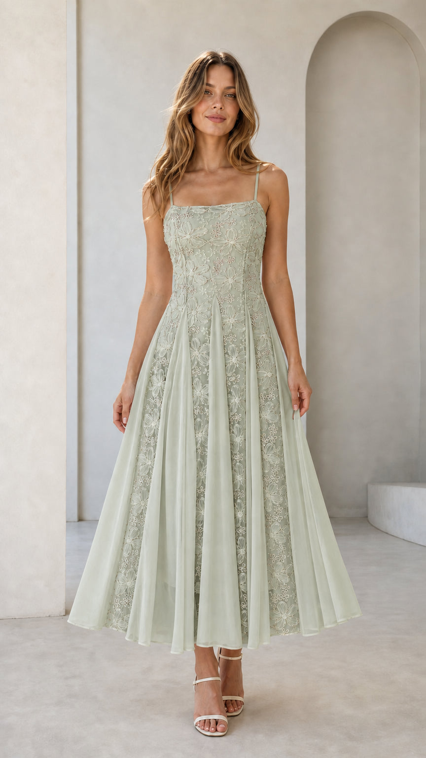 Front view of sage green floral embroidered midi dress on model