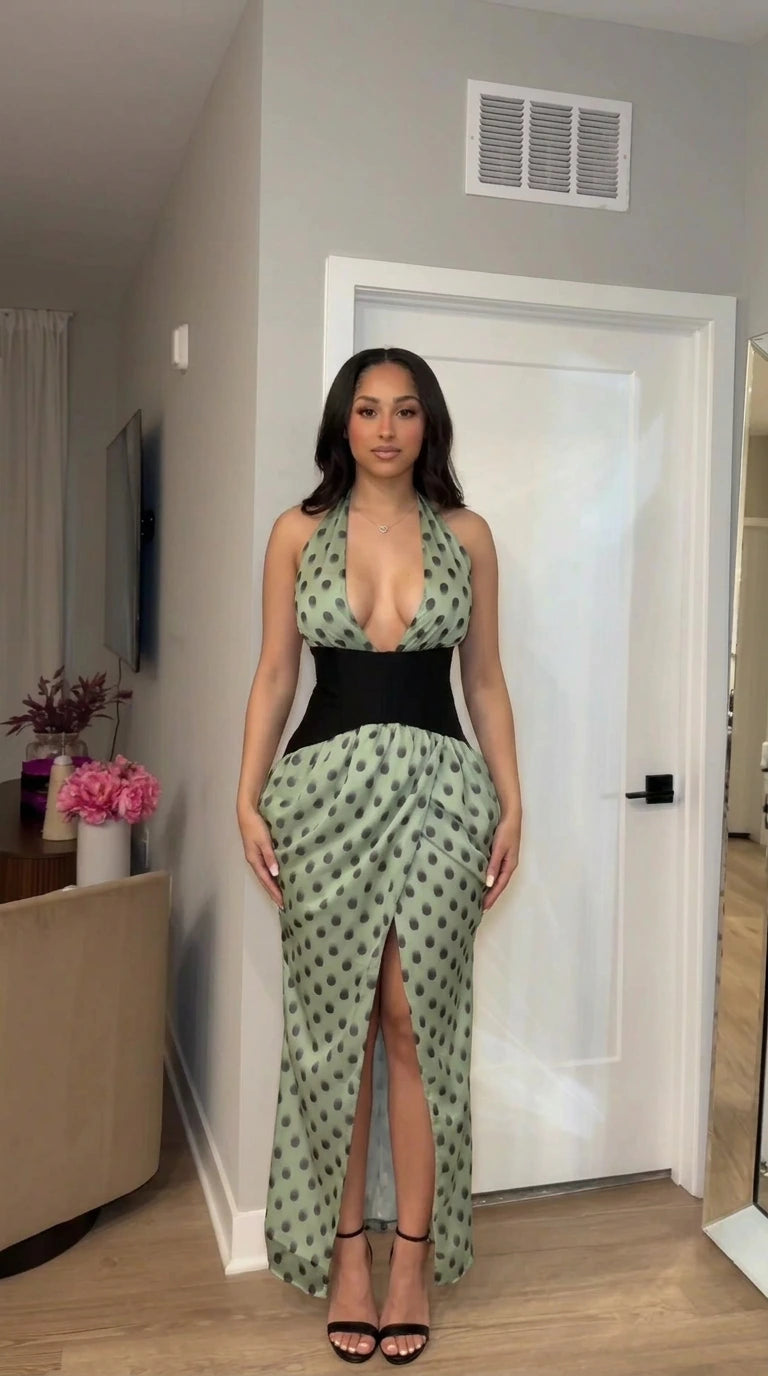 Front view of sage green polka dot halter maxi dress with black corset waist