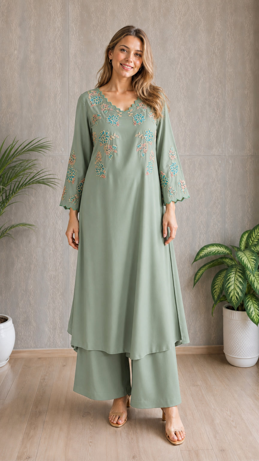 Model wearing sage green embroidered tunic and wide-leg pants set