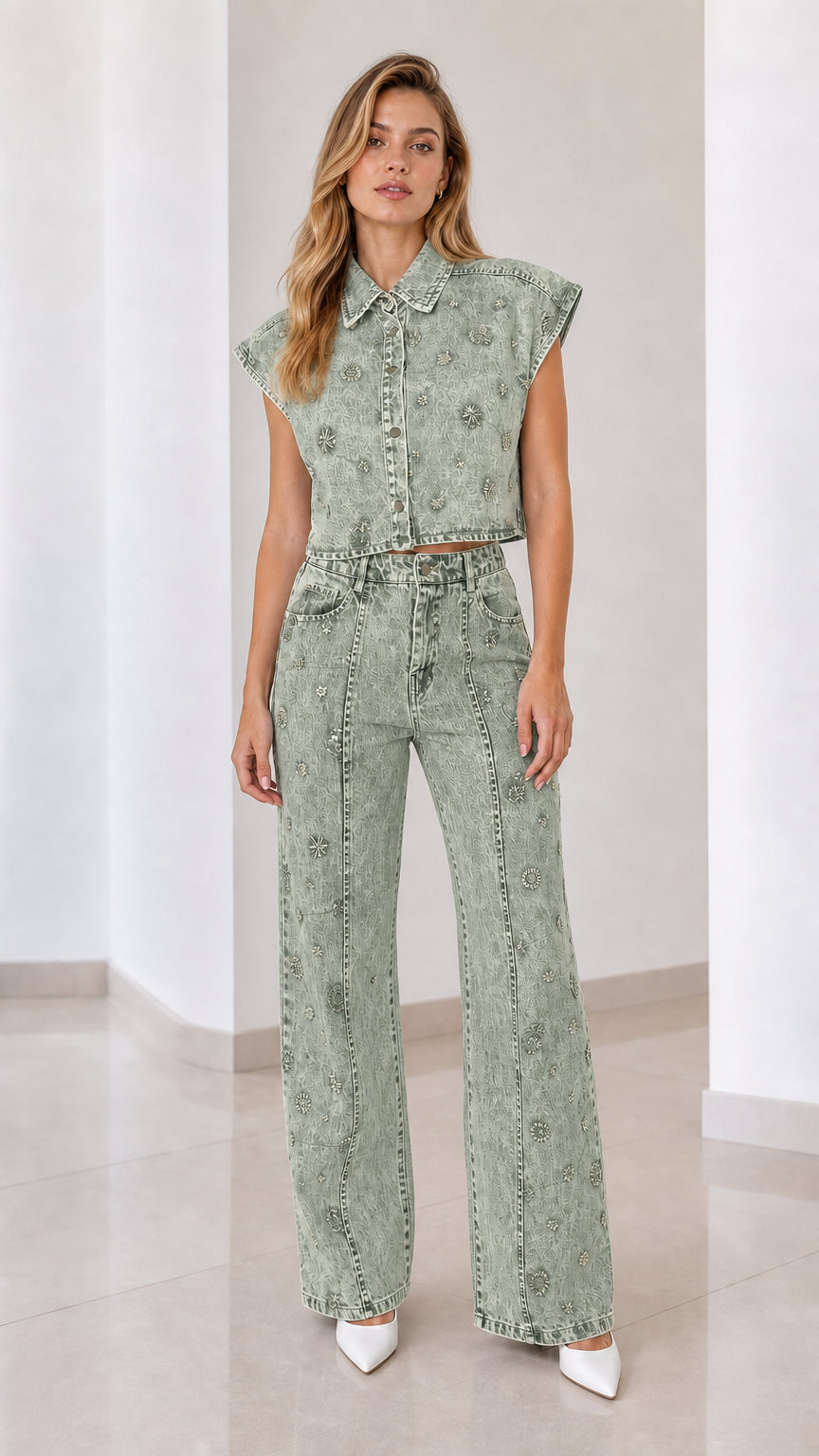 Front view of model wearing sage green embellished denim vest and matching wide-leg pants