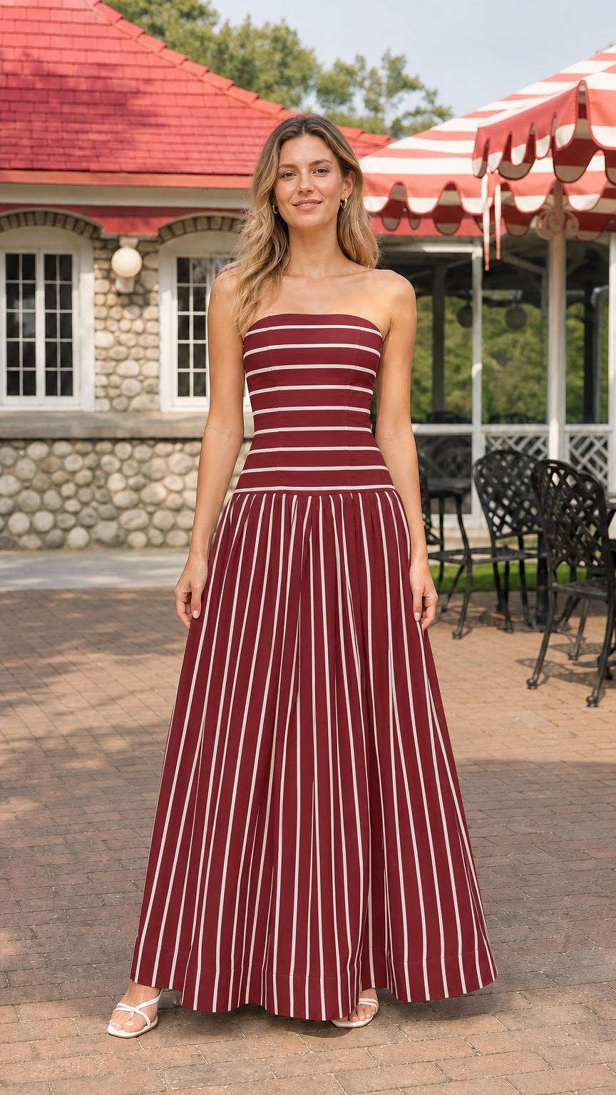 Model wearing burgundy and white striped strapless maxi dress