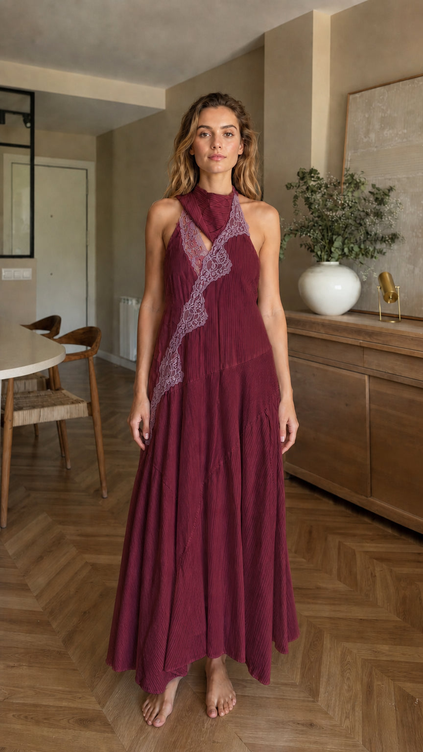 Front view of woman wearing burgundy halter maxi dress