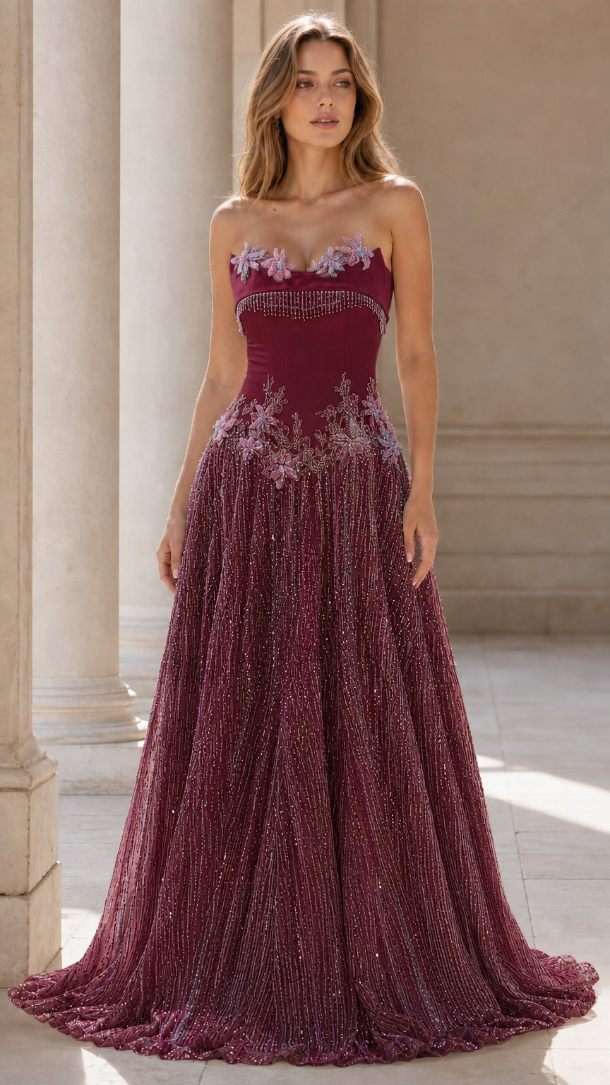 Front view of burgundy strapless beaded evening gown