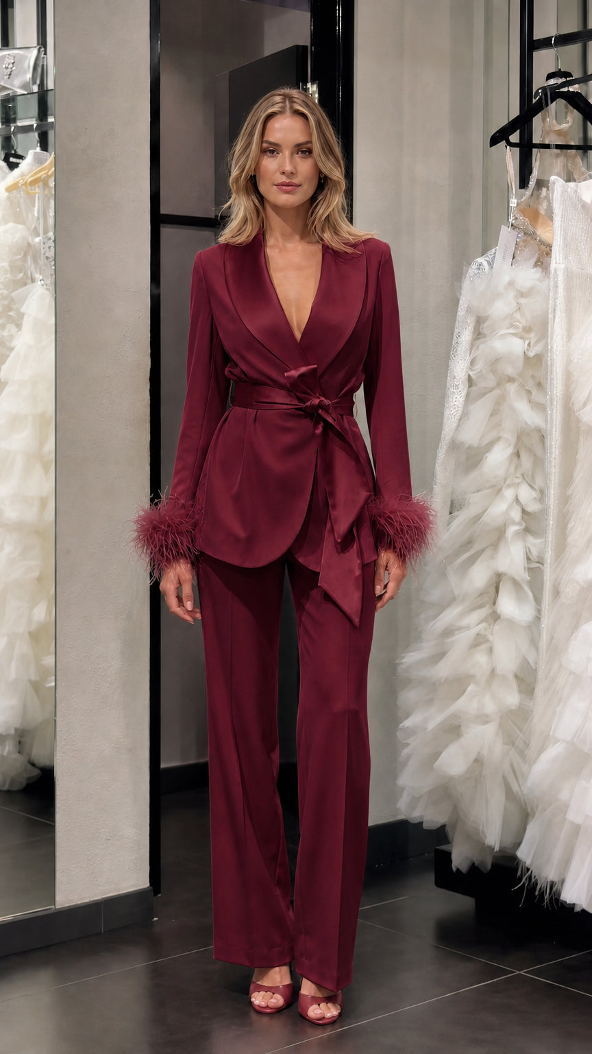 Model wearing burgundy satin feather cuff pantsuit set