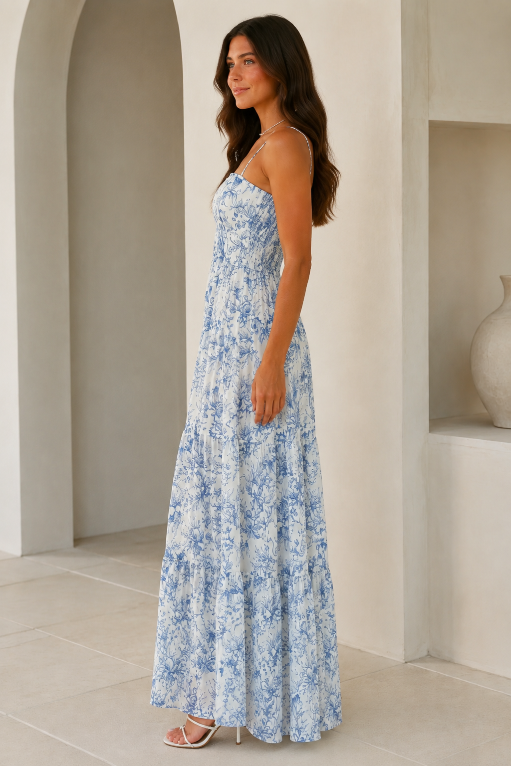 Side view of blue printed tiered maxi dress with spaghetti straps