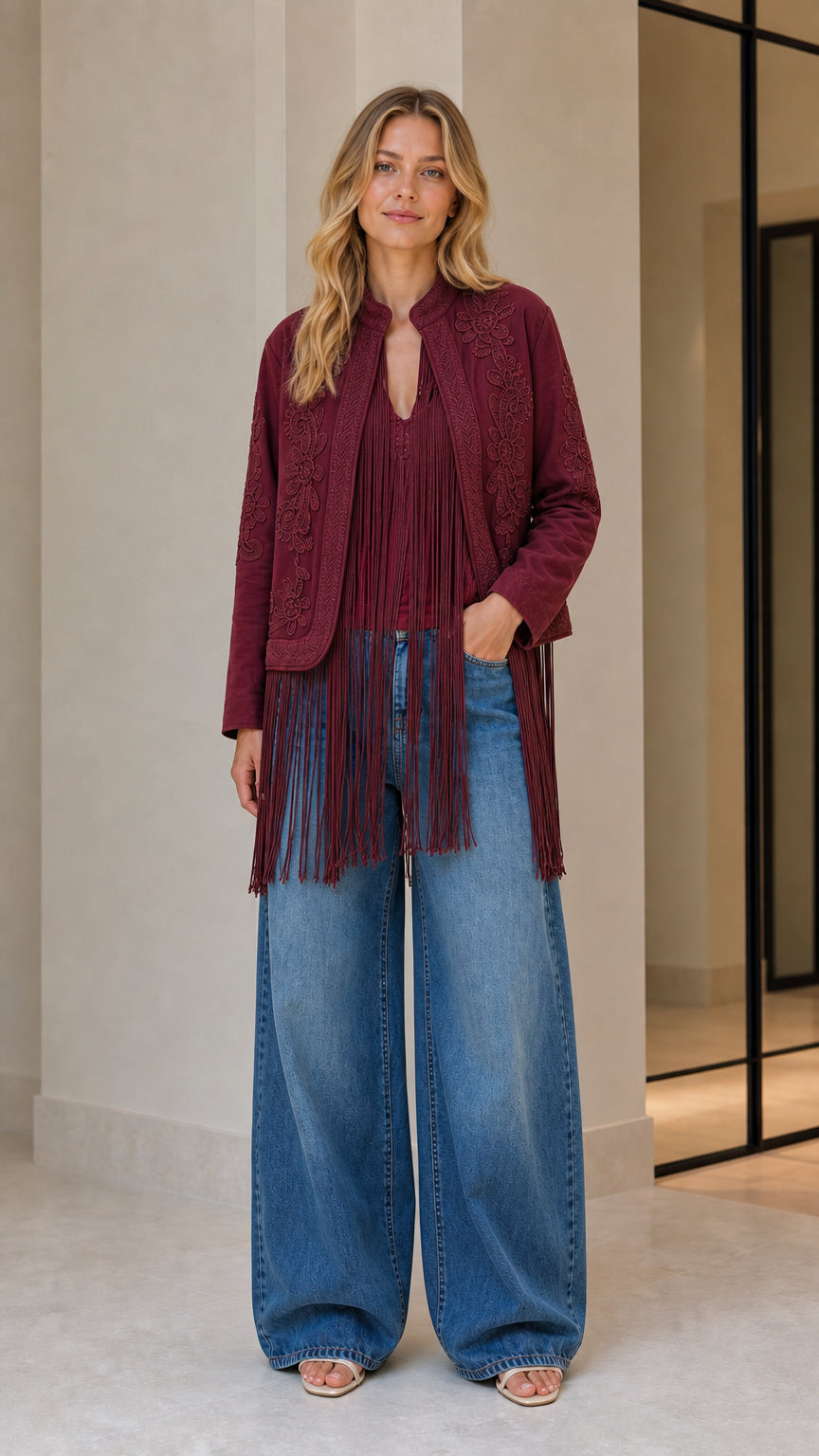 Model wearing burgundy embroidered fringe jacket
