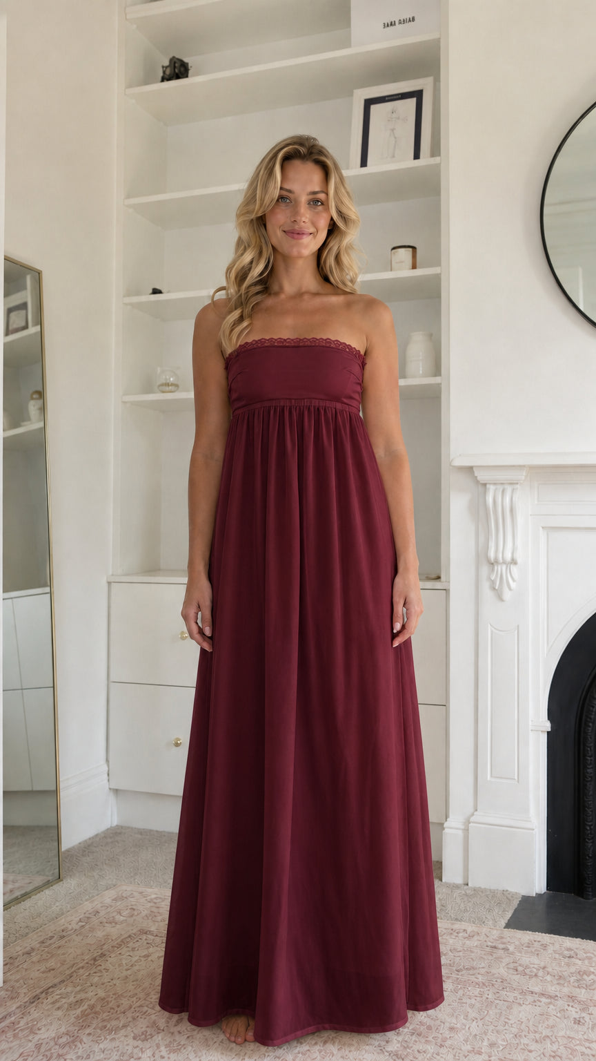 Woman wearing burgundy strapless maxi dress