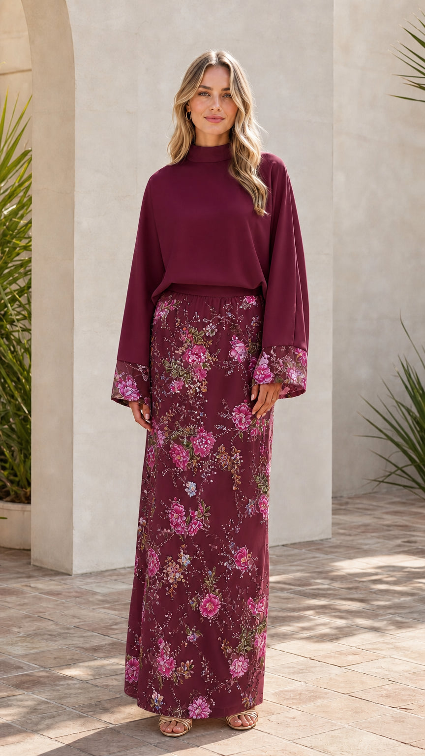 Model wearing burgundy two-piece floral embroidered maxi set
