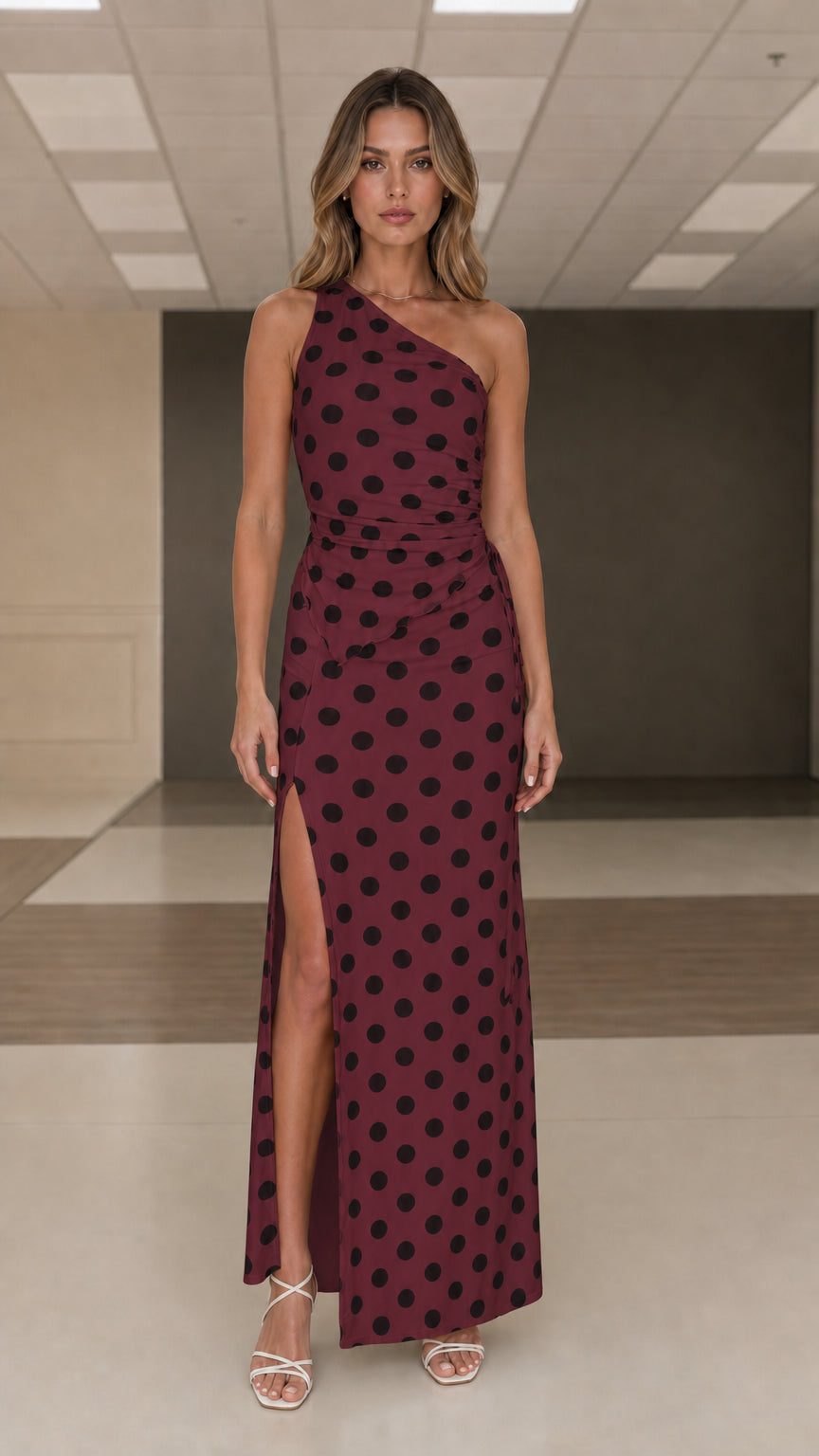 Front view of burgundy and black polka dot one shoulder maxi dress