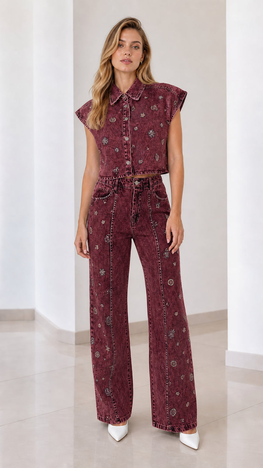 Front view of model wearing burgundy embellished denim vest and matching wide-leg pants