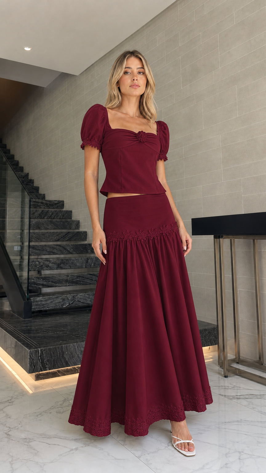Model wearing burgundy puff sleeve crop top and maxi skirt set