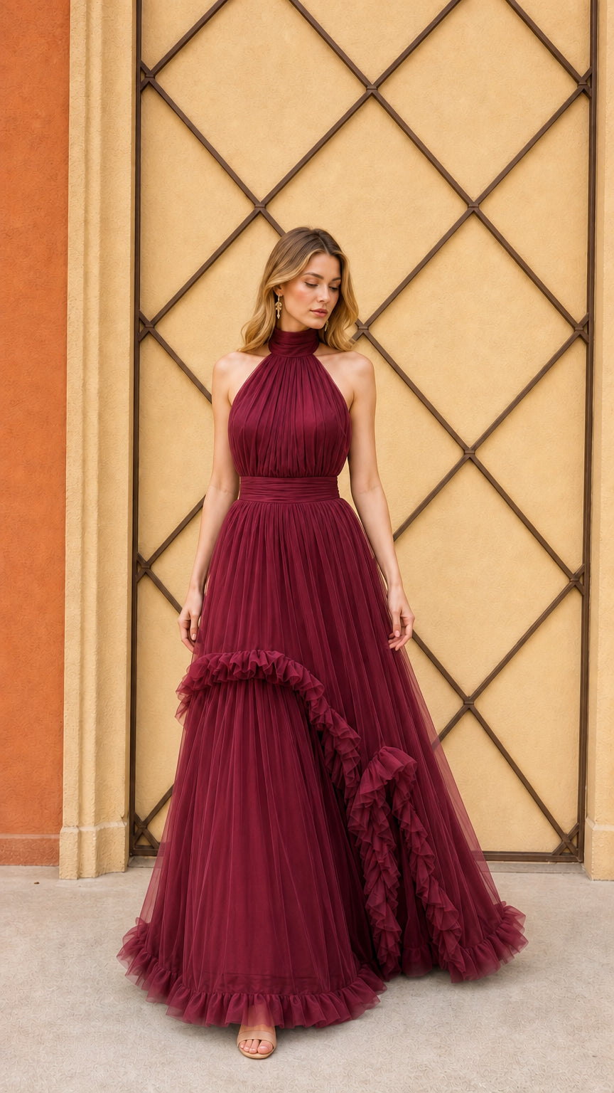 Model wearing burgundy halter pleated tulle evening gown