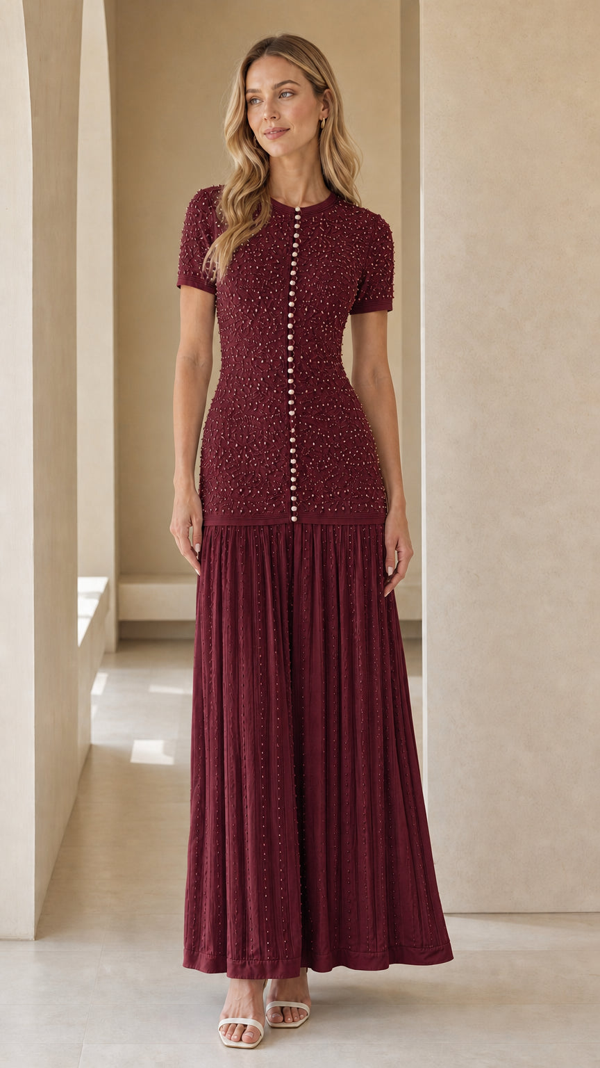 Front view of model wearing burgundy pearl-button textured knit maxi dress
