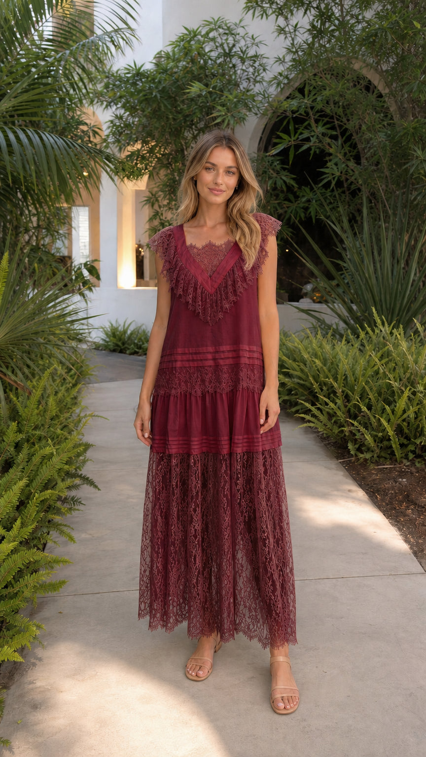 Front view of model in burgundy lace tiered maxi dress