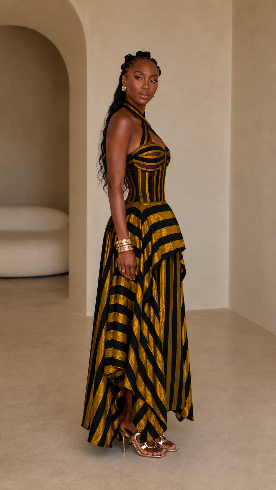Side view of mustard and black striped handkerchief hem maxi dress