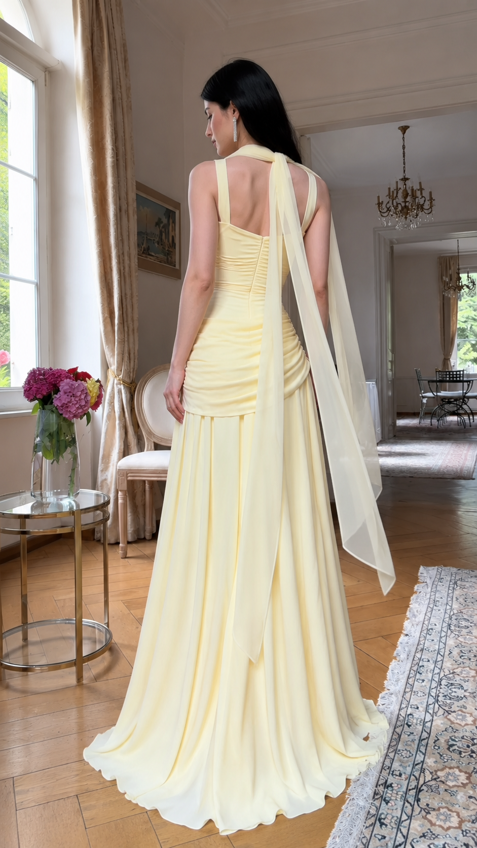 Back view of butter yellow formal gown showing gathered back and long scarf detail