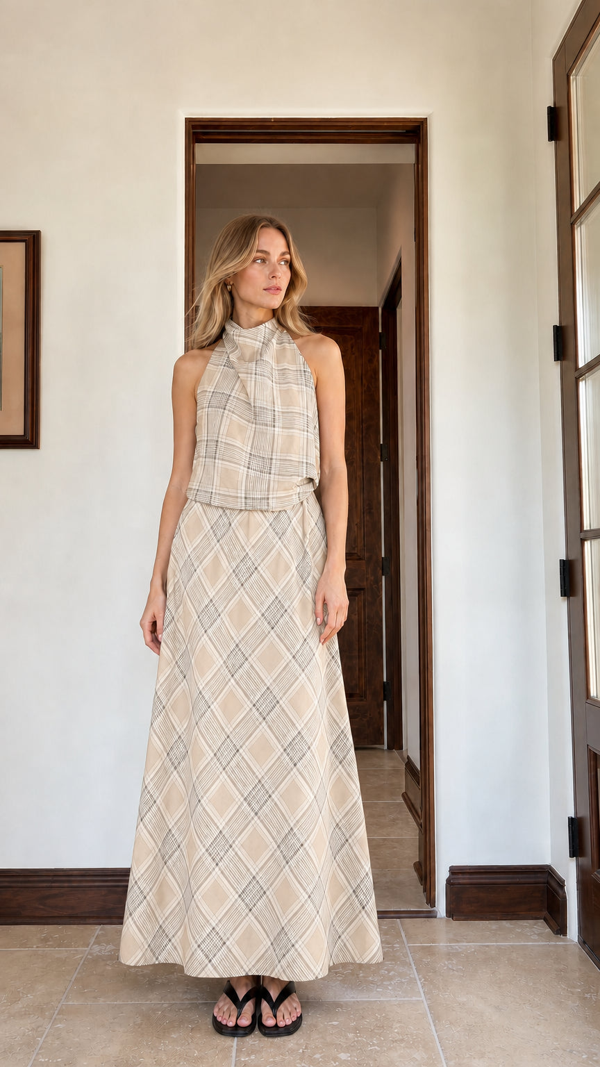 Woman wearing beige plaid halter top and matching maxi skirt