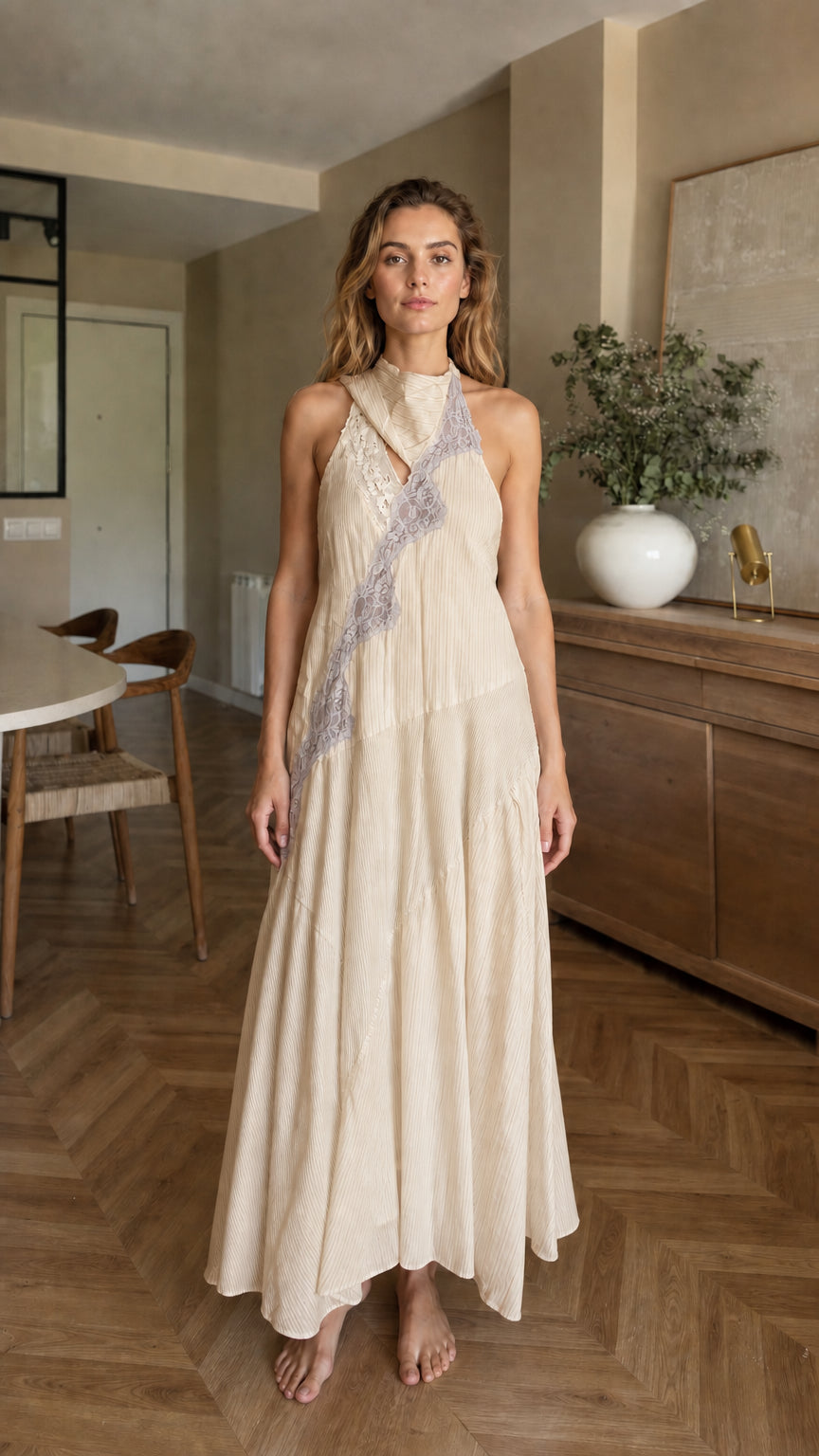 Front view of woman wearing beige halter maxi dress